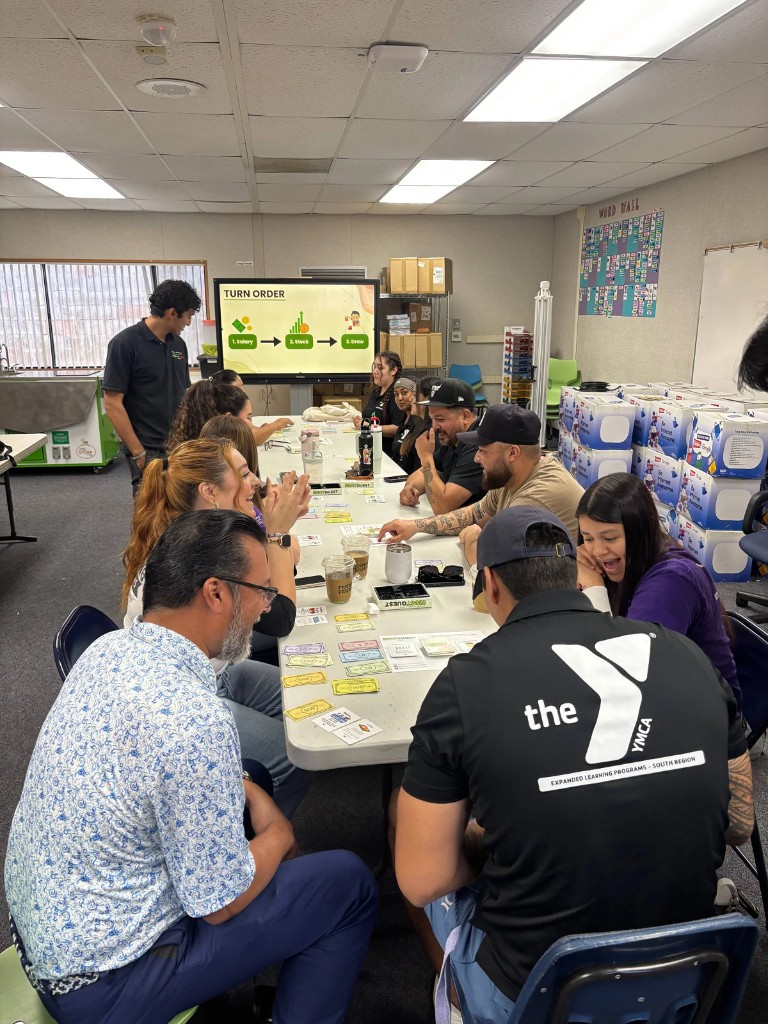 Youth-program staff playing InvestQuest at a YMCA educator workshop