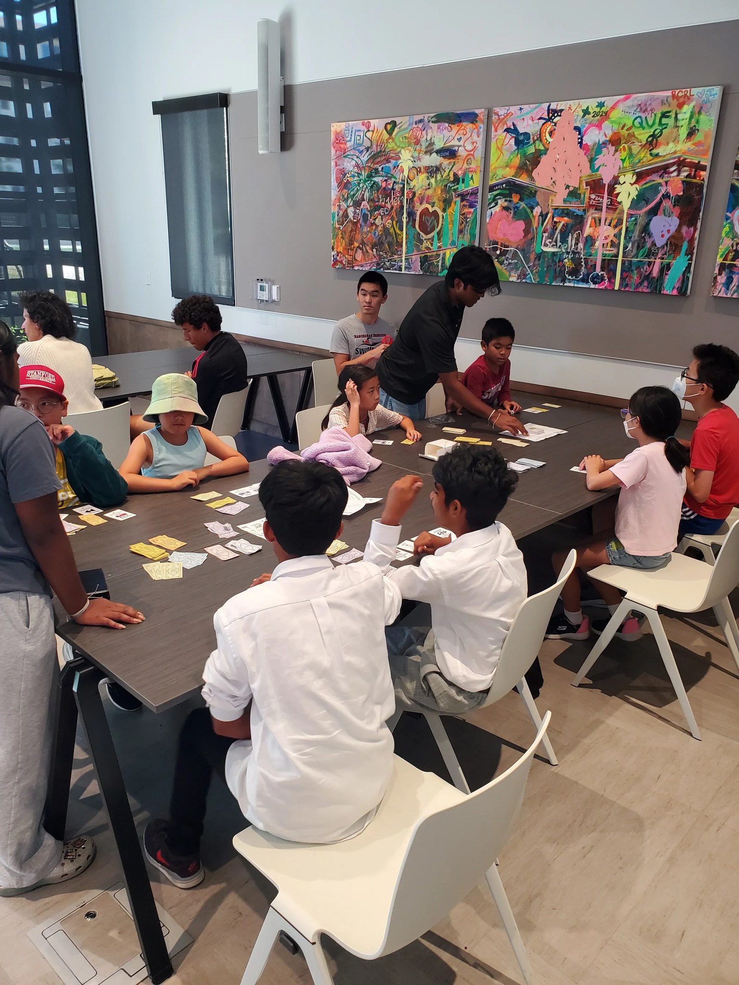 Kids playing InvestQuest at a library table